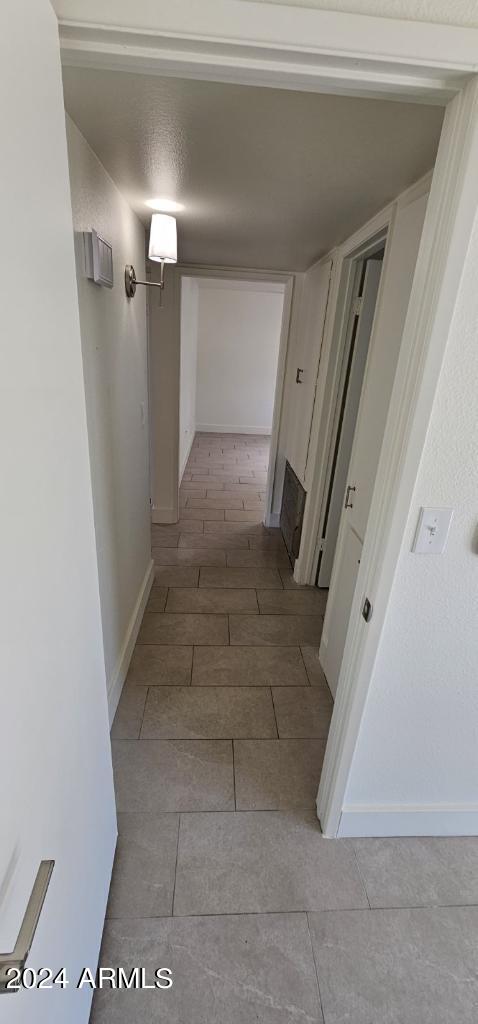 corridor featuring light tile patterned floors