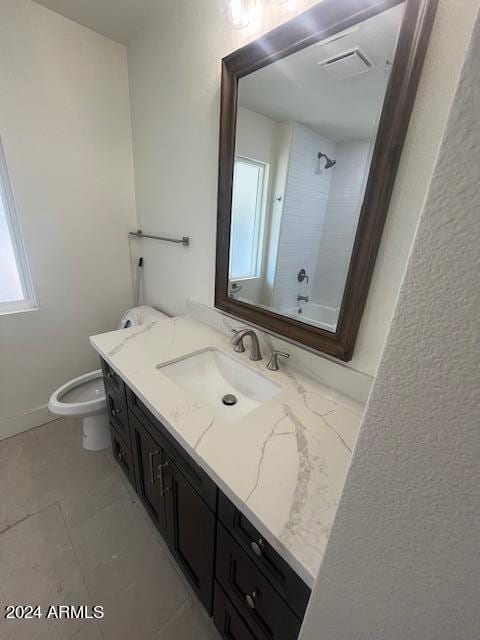 bathroom with vanity, toilet, and tile patterned floors