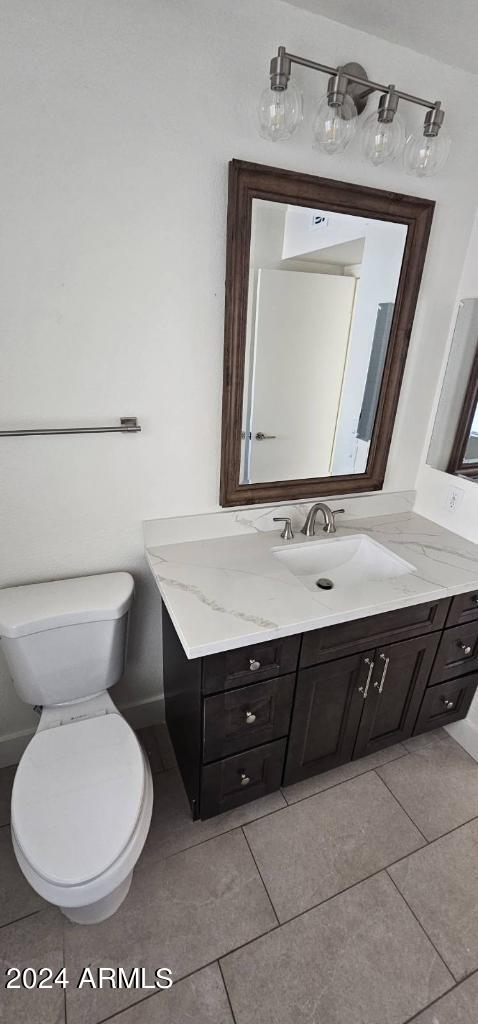 bathroom with vanity, toilet, and tile patterned floors