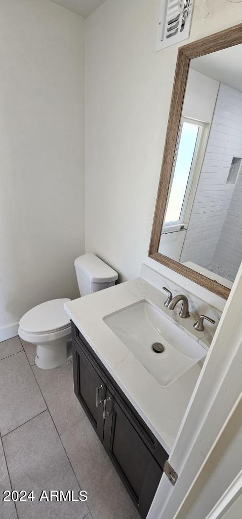 bathroom with tile patterned floors, toilet, and vanity