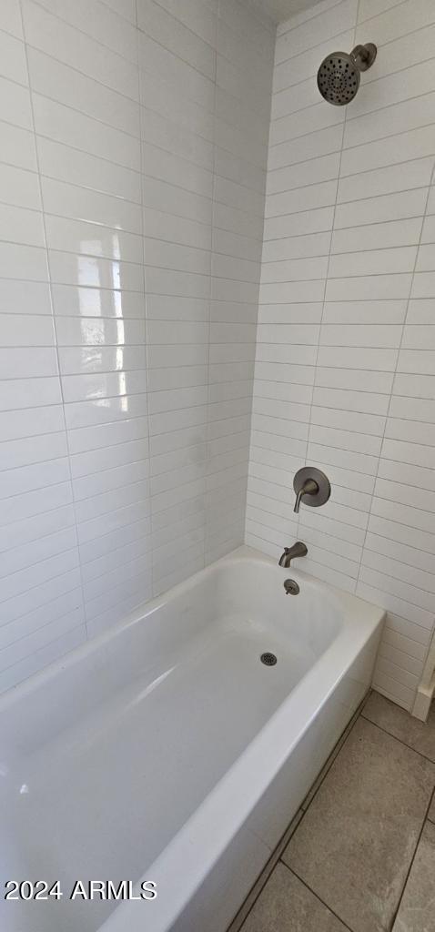 bathroom with tile patterned floors and shower / tub combination