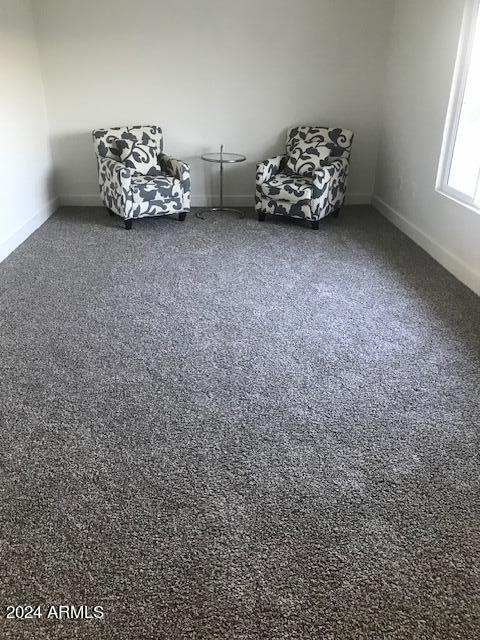 unfurnished room with dark carpet