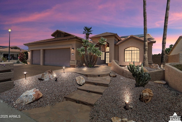 3797 N 156th Dr N, Goodyear, AZ 85395 - view of front of house featuring concrete driveway, an attached garage, solar panels, and stucco siding