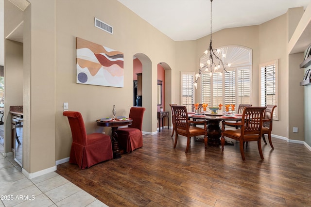 3797 N 156th Dr N, Goodyear, AZ 85395 - dining room with arched walkways, wood-type flooring, a chandelier, and visible vents