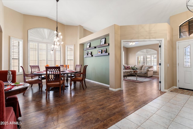 3797 N 156th Dr N, Goodyear, AZ 85395 - dining room with baseboards, a chandelier, wood finished floors, and high vaulted ceiling