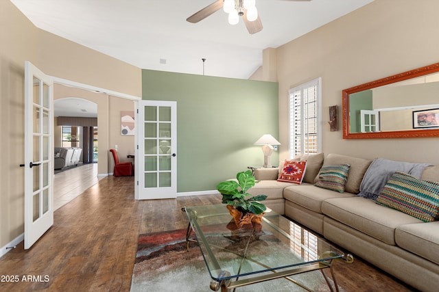 3797 N 156th Dr N, Goodyear, AZ 85395 - living room featuring arched walkways, a healthy amount of sunlight, french doors, and wood finished floors