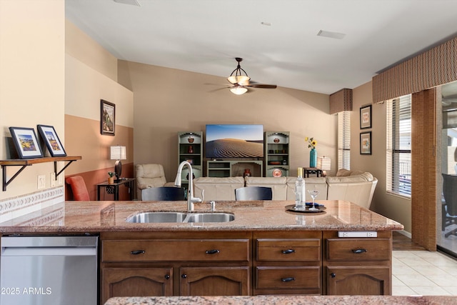 3797 N 156th Dr N, Goodyear, AZ 85395 - kitchen with light stone countertops, a sink, a ceiling fan, open floor plan, and stainless steel dishwasher