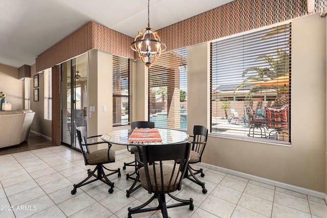 3797 N 156th Dr N, Goodyear, AZ 85395 - tiled dining room with baseboards and a chandelier