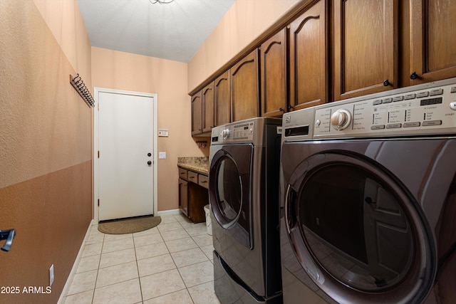 3797 N 156th Dr N, Goodyear, AZ 85395 - laundry area featuring cabinet space, light tile patterned floors, baseboards, a textured wall, and washer and dryer