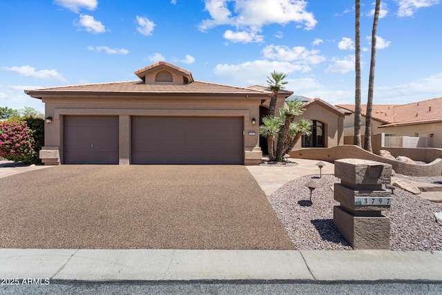 3797 N 156th Dr N, Goodyear, AZ 85395 - view of front of house featuring a garage, stucco siding, a tile roof, and aphalt driveway