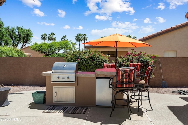 3797 N 156th Dr N, Goodyear, AZ 85395 - view of patio with an outdoor bar, fence, an outdoor kitchen, and a grill