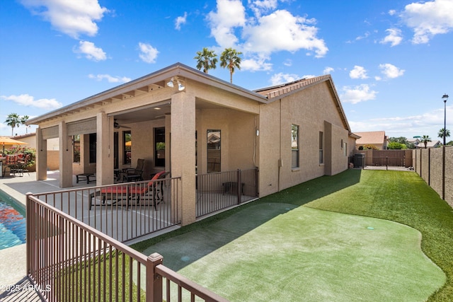 3797 N 156th Dr N, Goodyear, AZ 85395 - rear view of house with a patio, a fenced backyard, a ceiling fan, and stucco siding