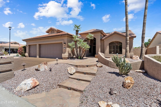 3797 N 156th Dr N, Goodyear, AZ 85395 - view of front of house with a tiled roof, an attached garage, roof mounted solar panels, and stucco siding