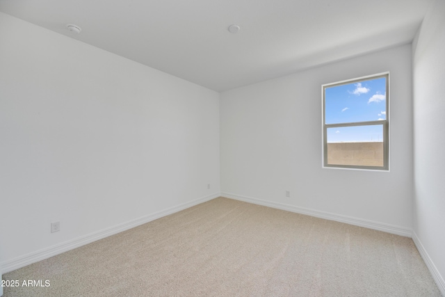 5875 N 193rd Dr, Litchfield Park, AZ 85340 - unfurnished room featuring baseboards and light carpet