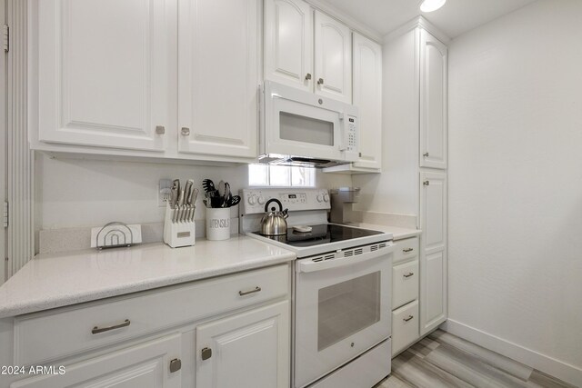 14910 N Kings Way Unit 206, Fountain Hills, AZ 85268 - kitchen with white appliances, white cabinetry, light countertops, and light wood-style floors