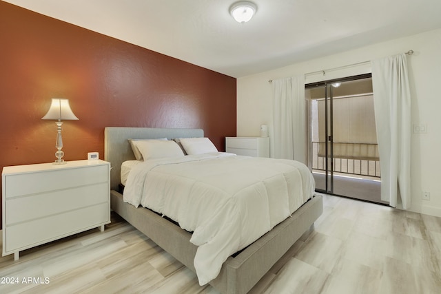 14910 N Kings Way Unit 206, Fountain Hills, AZ 85268 - bedroom with an accent wall, light wood-type flooring, and access to outside