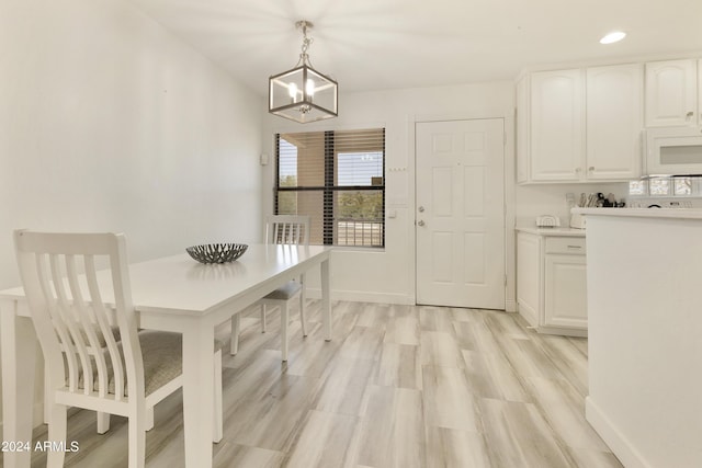 14910 N Kings Way Unit 206, Fountain Hills, AZ 85268 - dining area featuring a chandelier, baseboards, recessed lighting, and light wood-style floors