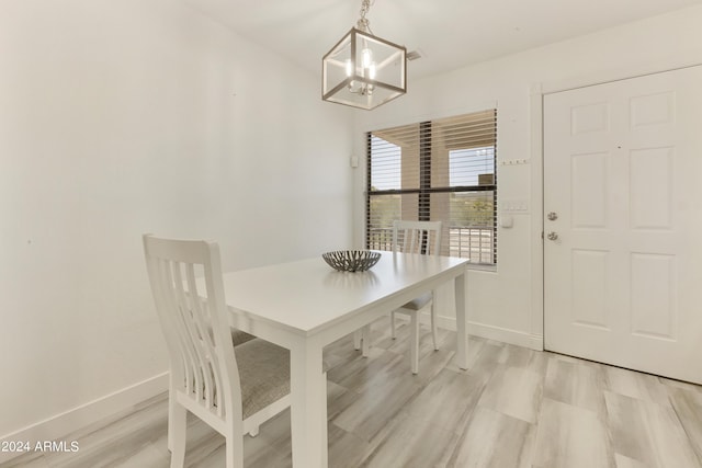 14910 N Kings Way Unit 206, Fountain Hills, AZ 85268 - dining room with a chandelier, baseboards, and light wood finished floors