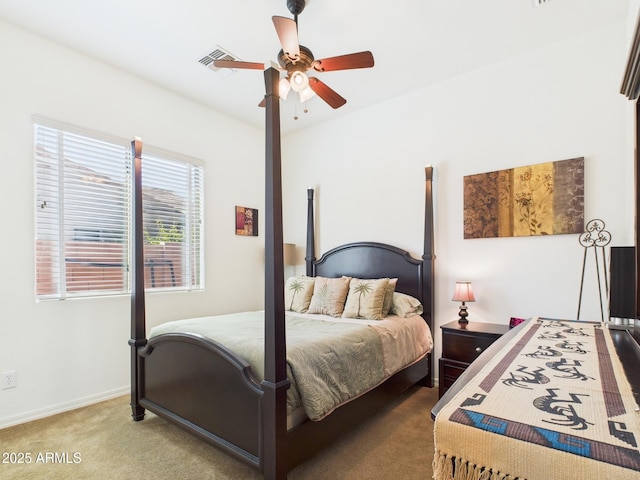 carpeted bedroom with visible vents, baseboards, and ceiling fan