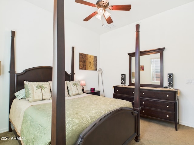 bedroom with visible vents, light colored carpet, and a ceiling fan