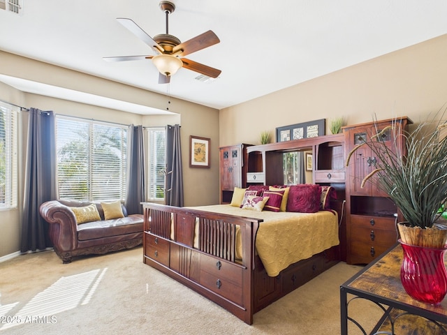 carpeted bedroom with visible vents and ceiling fan