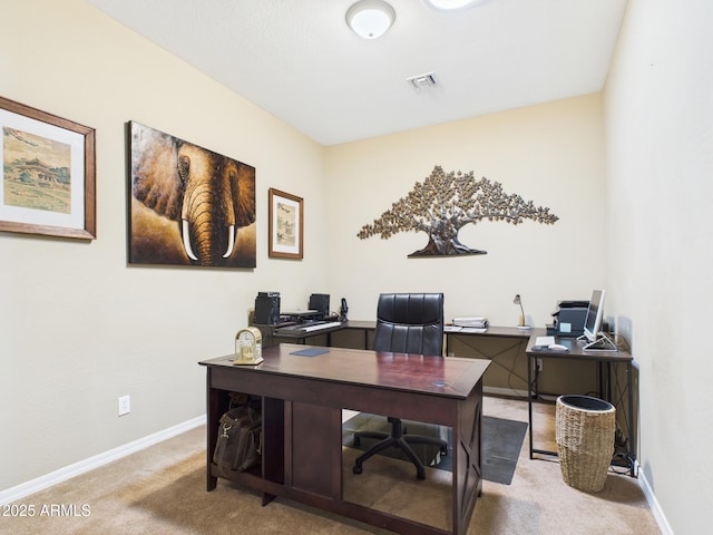 office space with visible vents, light carpet, and baseboards