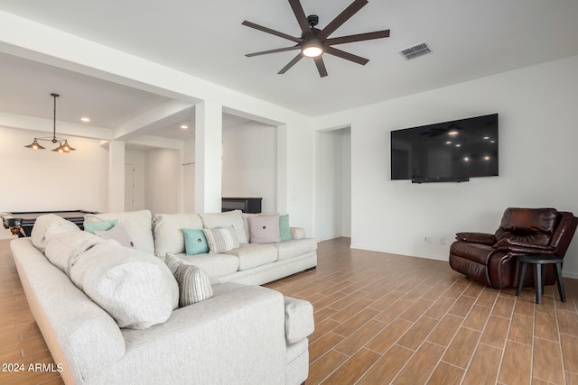 living room with hardwood / wood-style flooring and ceiling fan