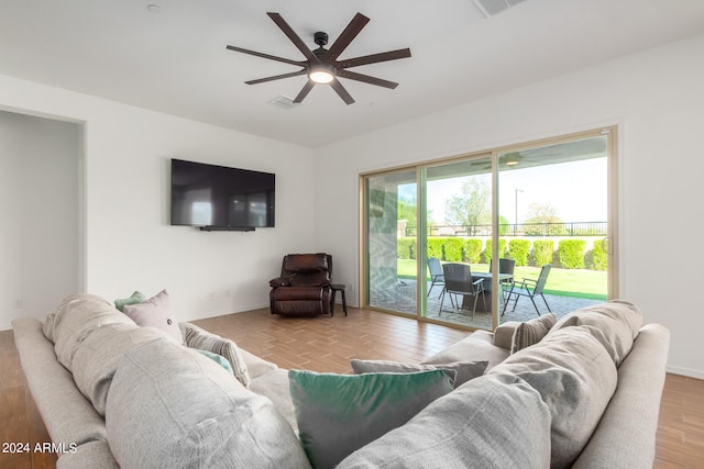 living room with ceiling fan and light wood-type flooring