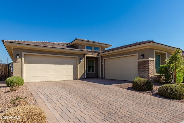 prairie-style home featuring a garage