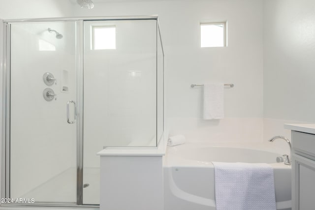 bathroom featuring separate shower and tub and vanity