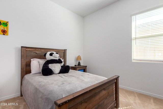 bedroom featuring light carpet