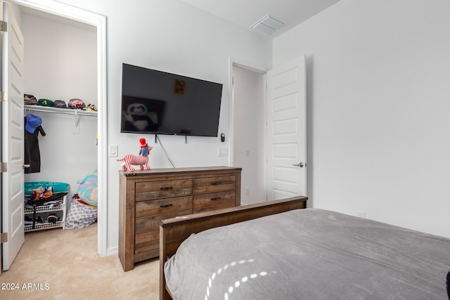 carpeted bedroom with a closet