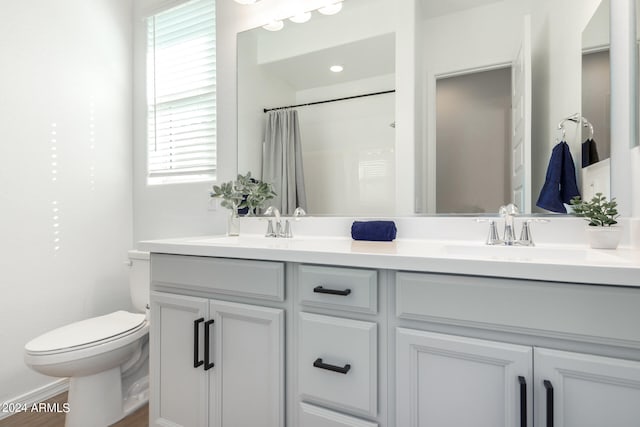 bathroom with a shower with curtain, vanity, toilet, and hardwood / wood-style flooring