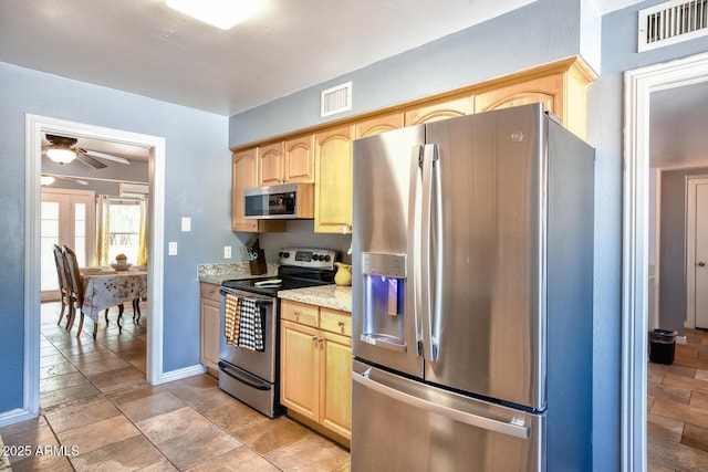 kitchen with visible vents, a ceiling fan, light brown cabinets, and stainless steel appliances