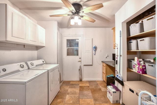 laundry room with stone finish floor, ceiling fan, washing machine and clothes dryer, cabinet space, and baseboards