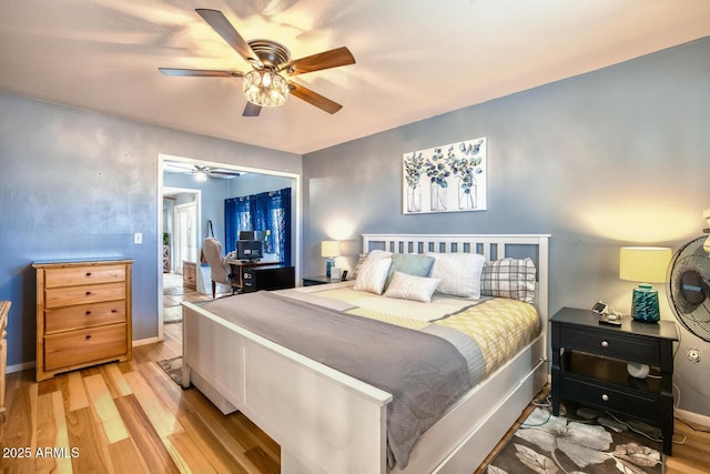 bedroom with a ceiling fan, baseboards, and light wood finished floors
