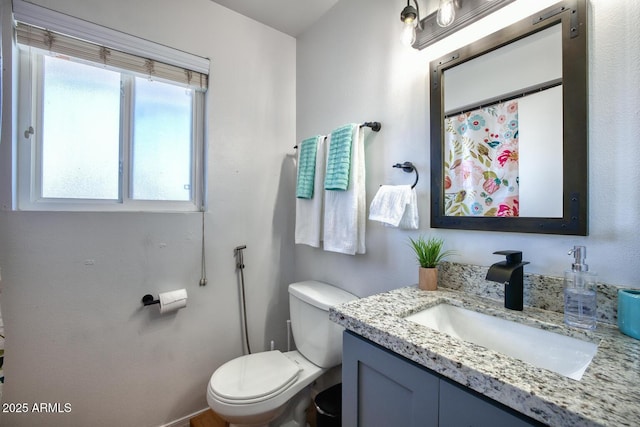 full bathroom with vanity and toilet