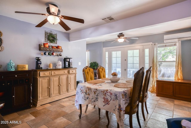 dining area with visible vents, ceiling fan, stone finish floor, and french doors