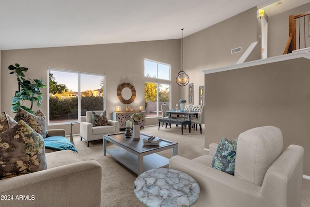 living room with light carpet and high vaulted ceiling