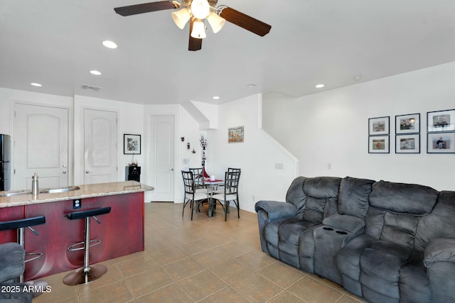 living room with tile patterned floors, visible vents, recessed lighting, and a ceiling fan