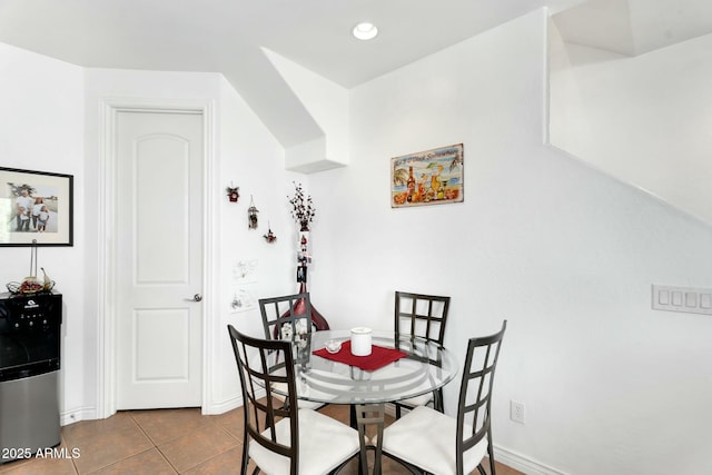 dining space with dark tile patterned floors, recessed lighting, and baseboards