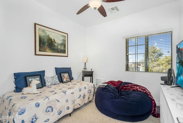 carpeted bedroom featuring visible vents and a ceiling fan