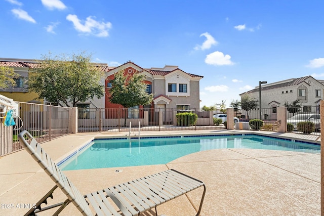 community pool featuring a patio area and fence