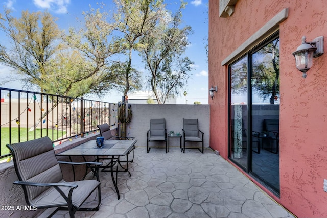 view of patio featuring fence