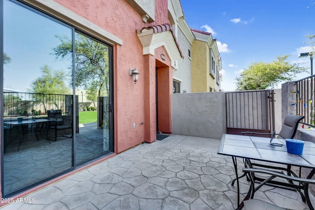 view of patio featuring fence