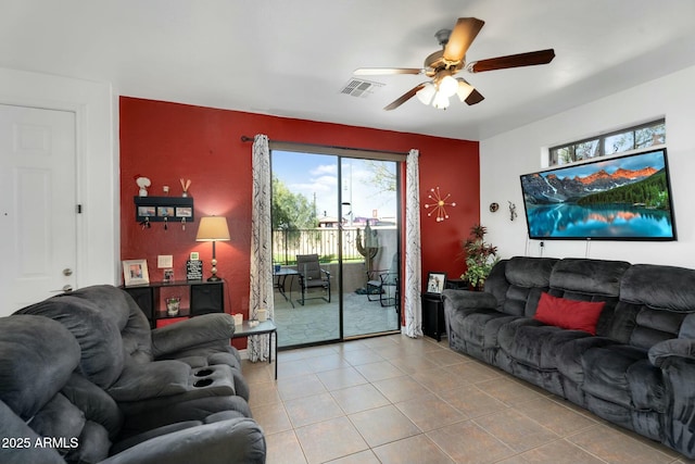 tiled living room featuring visible vents and ceiling fan