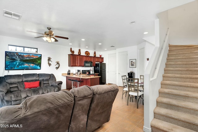 living area with visible vents, a ceiling fan, recessed lighting, stairway, and light tile patterned floors