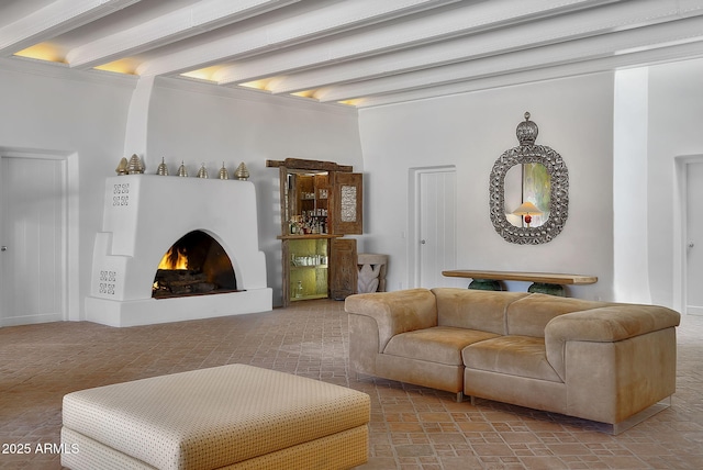 2671 Hwy 82, Patagonia, AZ 85624 - living room with brick flooring, a warm lit fireplace, and beamed ceiling