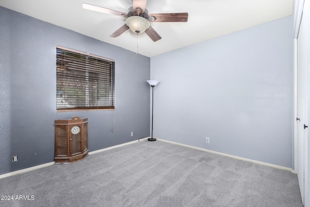 unfurnished room featuring light carpet and ceiling fan