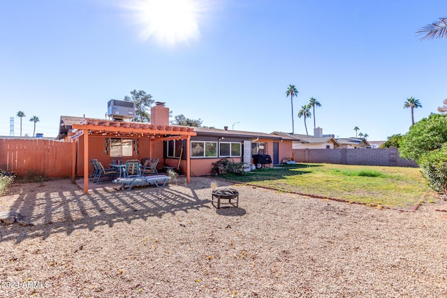 rear view of house featuring a pergola, central air condition unit, a fire pit, a yard, and a patio